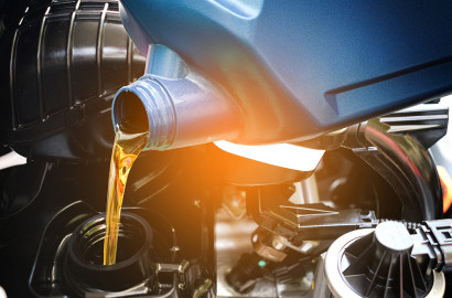 oil being poured into car change with light gradient overlay